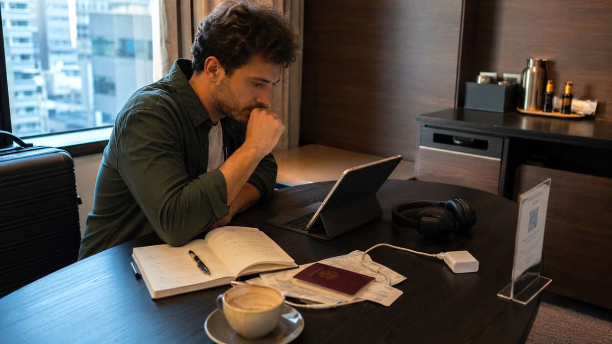 Traveler reviewing booking details and travel risks in an airport terminal before confirming a trip